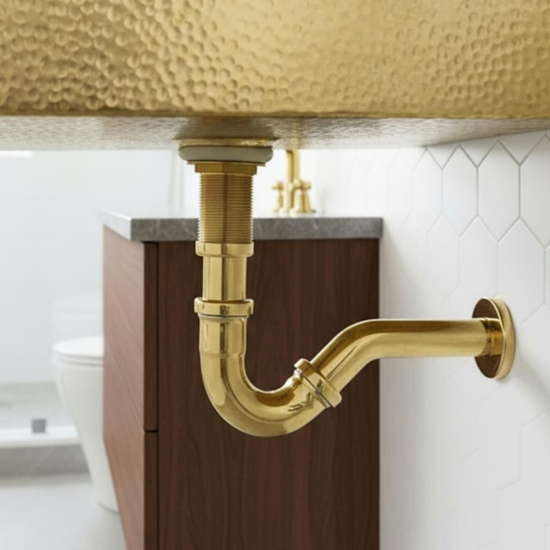 Unlacquered brass P-trap kit installed in a luxury bathroom