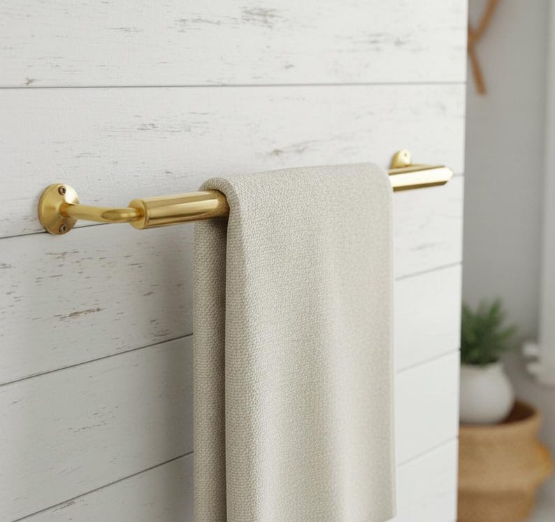 Brass towel bar installed in a luxury bathroom