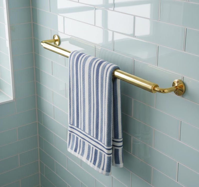 Minimalist brass rail matching bathroom fixtures