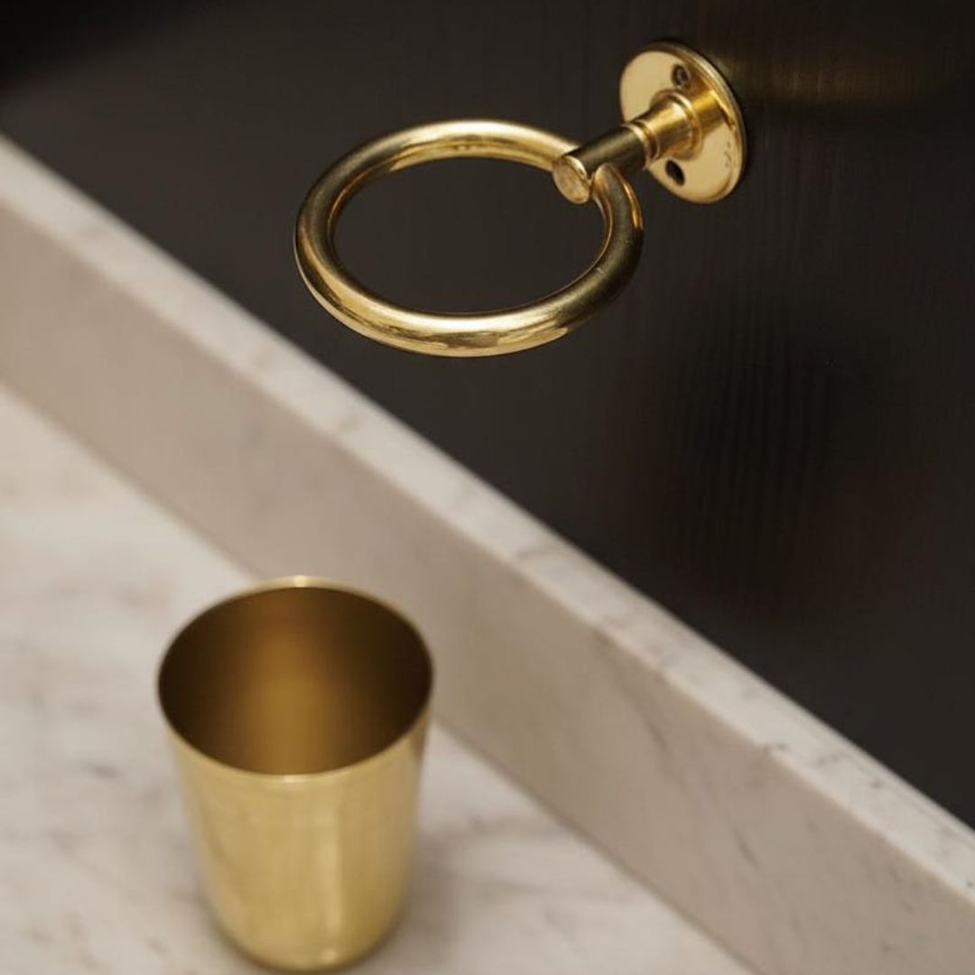 Detailed view of hand-polished brass toothbrush holder