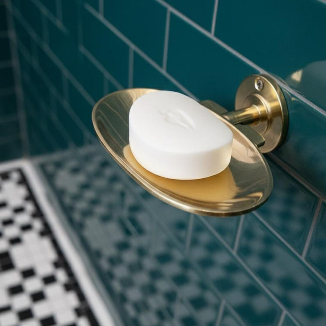 Minimalist wall-mounted brass holder detail