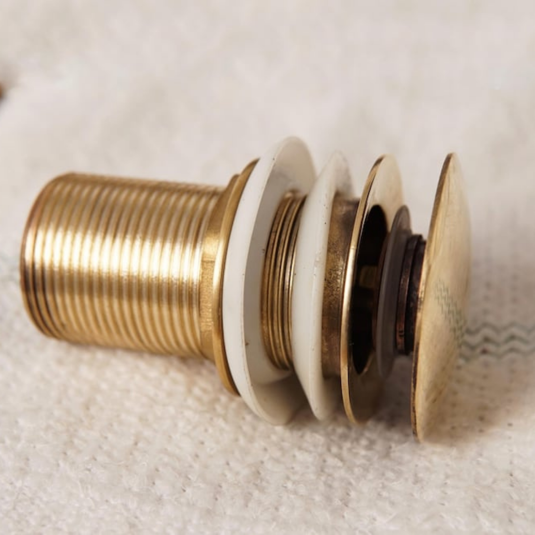 Detailed view of hand-finished unlacquered brass sink stopper
