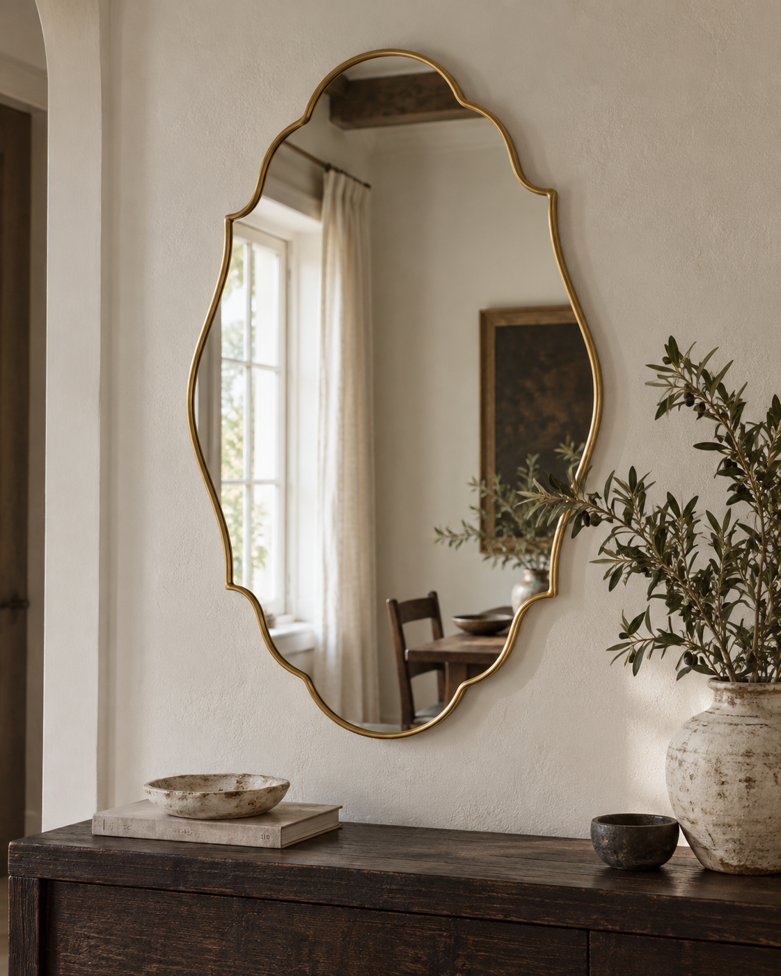 Celestine Renaissance brass mirror in a dining room