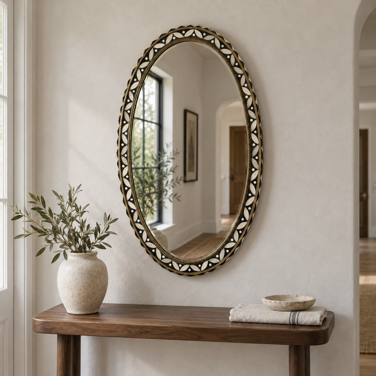 Noura oval bone inlay mirror photographed in a naturally lit entryway
