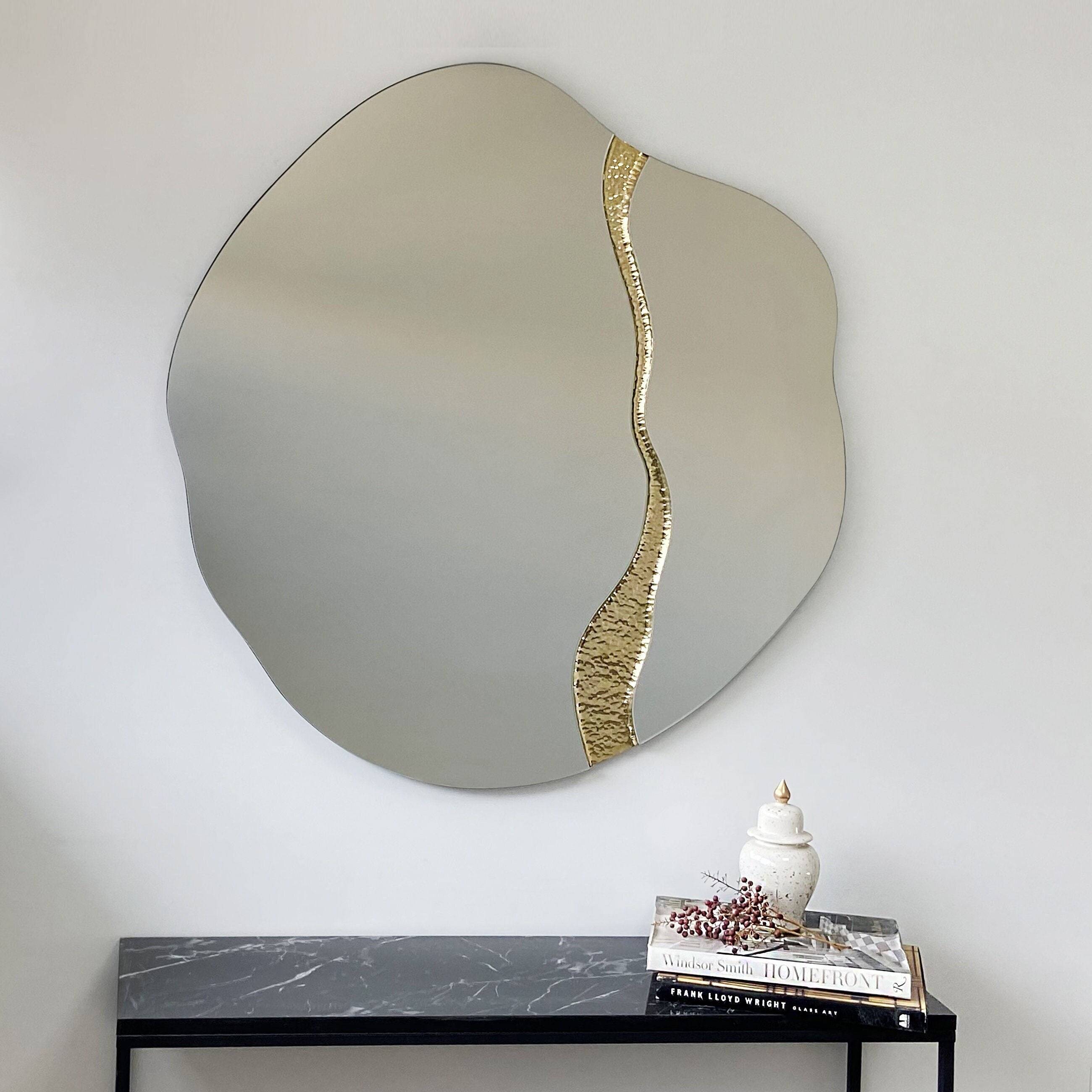 Fracture organic brass wall mirror in styled bathroom