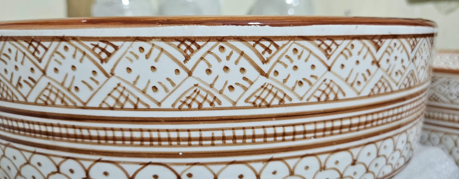 Sienna original workshop photograph — close-up of hand-painted geometric borders