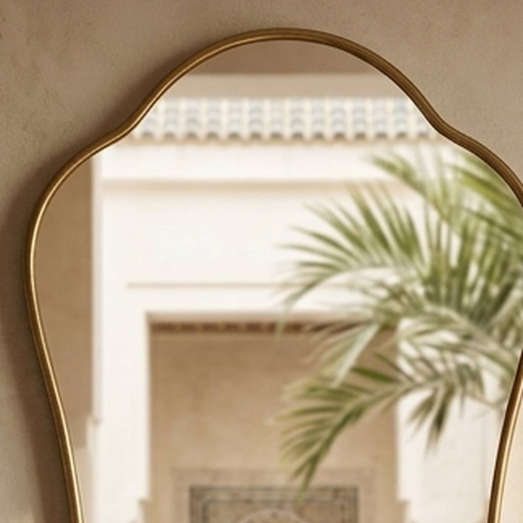 Detail of the Alya brass frame edge and bevelled mirror glass